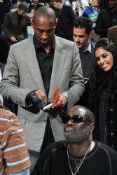 Kobe Bryant signs autograph as wife Vanessa Bryant smiles.jpg