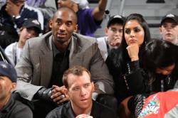 Kobe in gray suit sitting with wife Vanessa Bryant.jpg