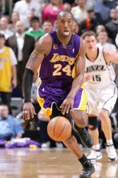 Kobe sticks out his tongue as he races up court with the ball.jpg