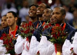 Kobe Bryant and team USA listen to the National Anthem as the US flag is raised.jpg