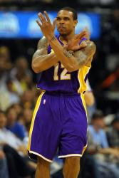 Shannon Brown makes a cross with his arms.jpg