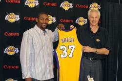 Ron Artest hold up his new Lakers jersey with Mitch Kupchak.jpg