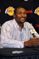 Ron Artest in a striped shirt listens to a question during his Lakers introduction.jpg
