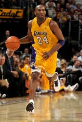 Kobe Bryant sticks out his tongue as he dribbles up court.JPG