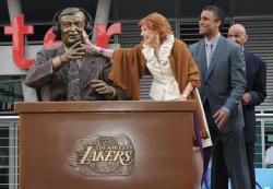 Marge Hearn touches the Chick Hearn statue with Rick Fox and Stu Lance nearby.JPG