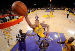 Shannon Brown jumps over Jason Richardson in a dunk attempt as Kobe Bryant goes woo.JPG
