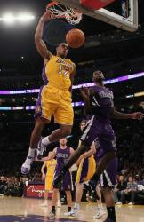 Shannon Brown right handed power dunk as Tyreke Evans looks on.JPG