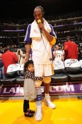 Kobe Bryant does the post game interview with his daughter Gianna by his side.jpg