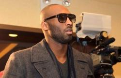 Kobe Bryant with a beard and sunglasses wearing a gray jacket.JPG