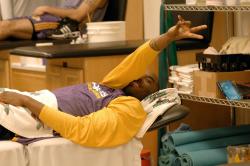 kobe gives peace symbol fullj.    lakers media 9 37 12 pm.jpg