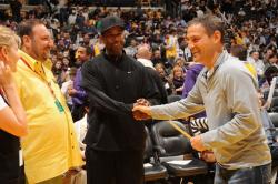 Laker Fans Joel Silver Denzel Washington and Ari Emanuel greet each other courtside.jpg