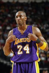 Kobe Bryant tugs at his Laker road jersey with game face on.jpg