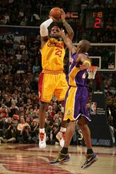 Kobe Bryant tries to distract Lebron James shooting a jumper.jpg